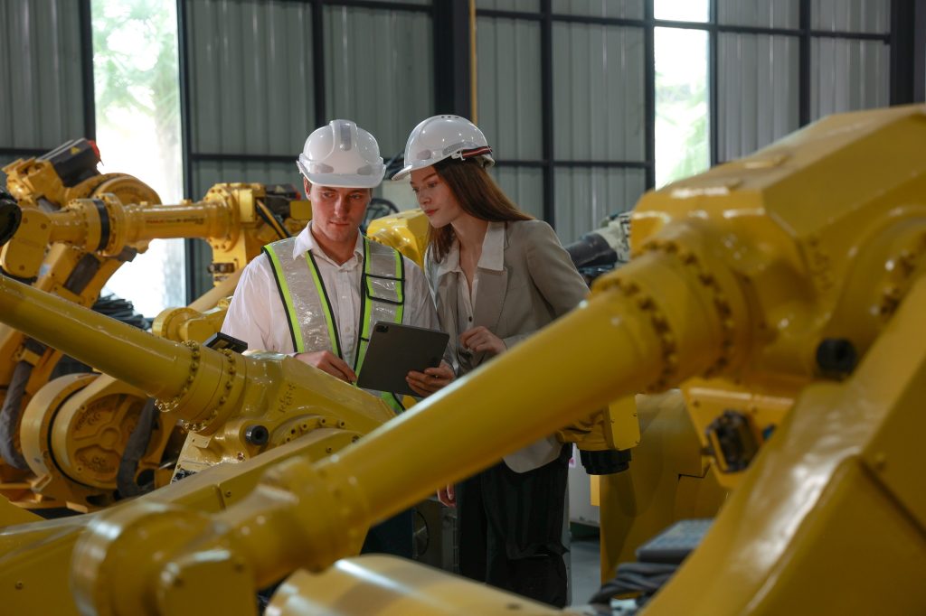 Industrial Team Evaluating Automation Processes in Robotics Unit